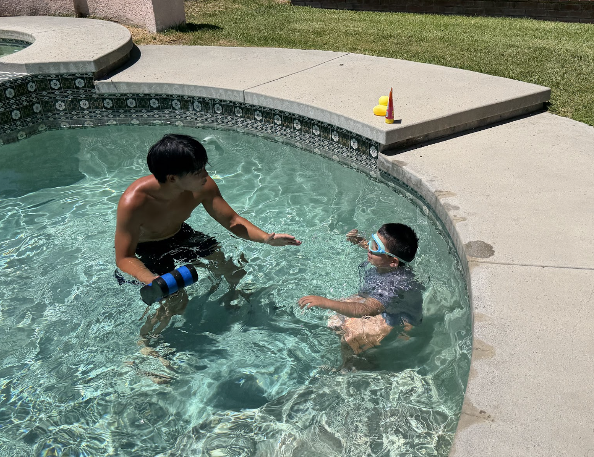 A Float coach working one-on-one with a young swimmer