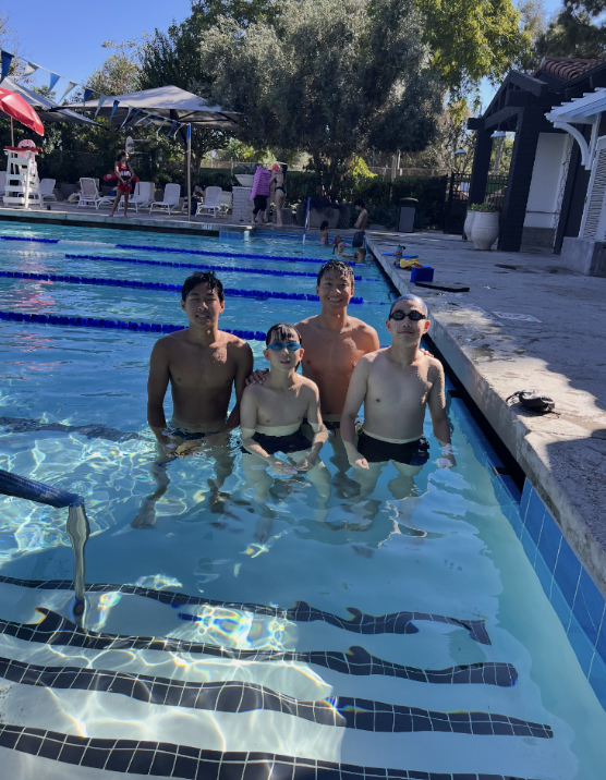 Coaches and swimmers together in the lap pool after practice