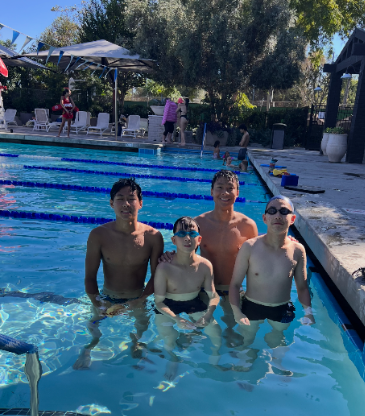 Coach and swimmers together in the lap pool after practice